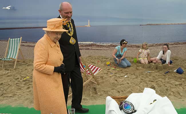 Queen Elizabeth II views a beach scene as she tours a Diamond Jubilee exhibition celebrating 60 years of reign at Corporation Quay, Sunderland as part of her Diamond Jubilee visit to the North East./ Picture by: Arthur Edwards/The Sun / PA Archive/Press Association Images.