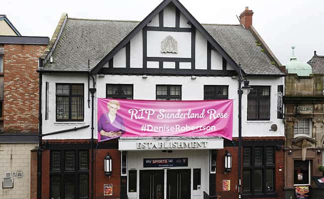 A pink banner on the Establishment pub next to Sunderland Minster where the funeral of TV agony aunt Denise Robertson will take place./Picture by: Owen Humphreys / PA Wire/Press Association Images.