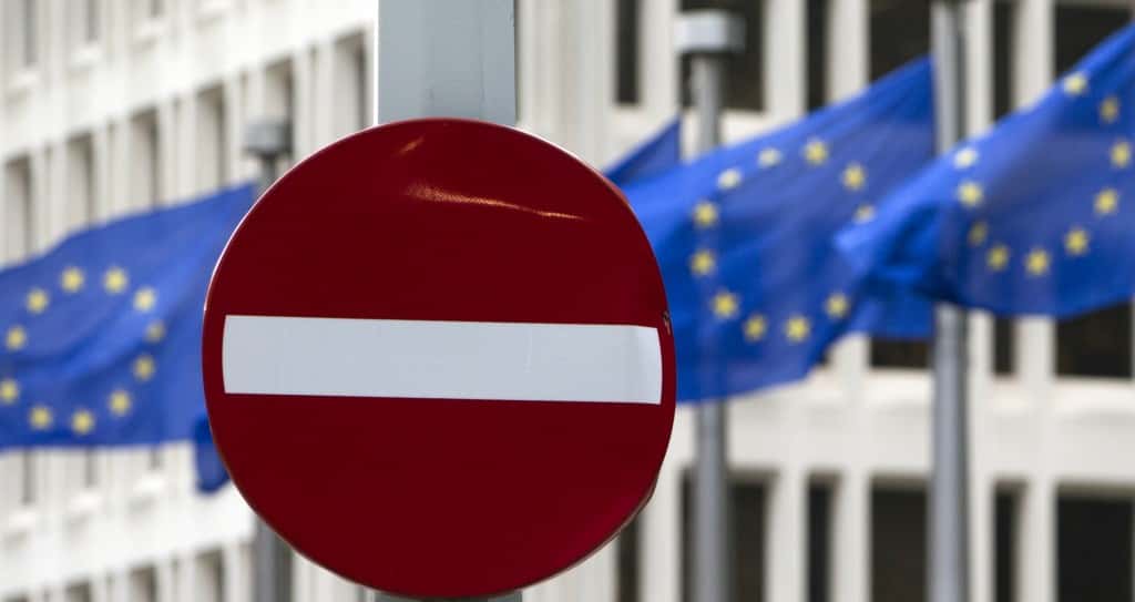 EU flags flutter in the wind in back of a no entry street sign in front of EU headquarters in Brussels on Friday, June 24, 2016. Voters in the United Kingdom voted in a referendum on Thursday to decide whether Britain remains part of the European Union or leaves the 28-nation bloc. Results will be known later on Friday. (AP Photo/Virginia Mayo)