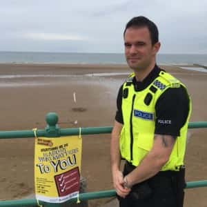 A/Sgt Sam Brown on the seafront/by Northumbria Police.