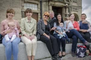 (Background) Portfolio Holder for Public Health, Wellness and Culture, Cllr John Kelly, joins (second left) Director for Public Health Health, Gillian Gibson, and (third left)Portfolio Holder for Children’s Services, Cllr Louise Farthing, and mothers and babies from across Sunderland in Keel Square join the Bosom Buddies event to promote breast-feeding/by Sunderland City Council.