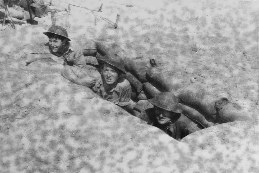 George Waller takes cover in a slit trench during the North African Campaign in the Second World War.