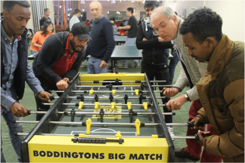 refugees playing with church member