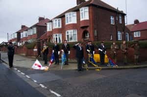 Colour Guard with colours lowered as the Last Post is played.