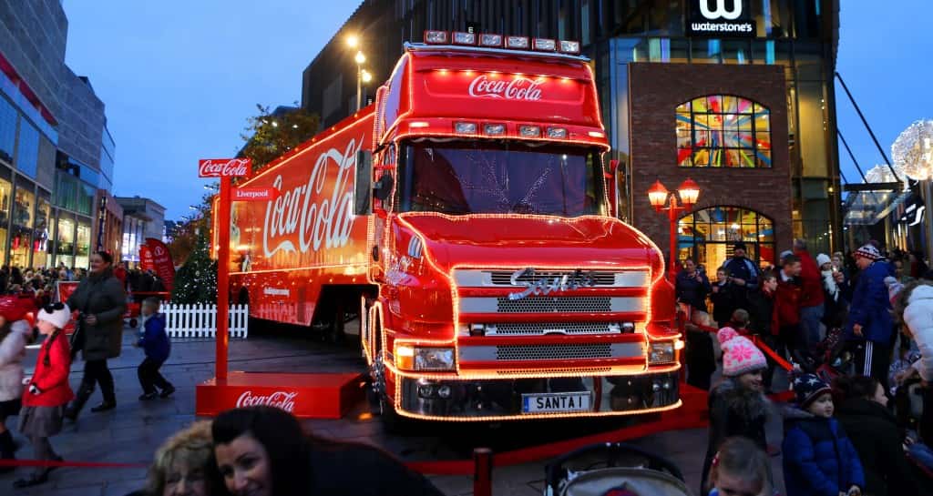 Shoppers pass the Christmas lights and the Coca-Cola truck at Liverpool 1 in Liverpool City Centre.