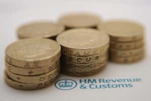 File photo dated 27/01/15 of pound coins next to the HM Revenue & Customs logo, as complaints against HM Revenue and Customs are at their highest level since the financial crisis, according to new figures.