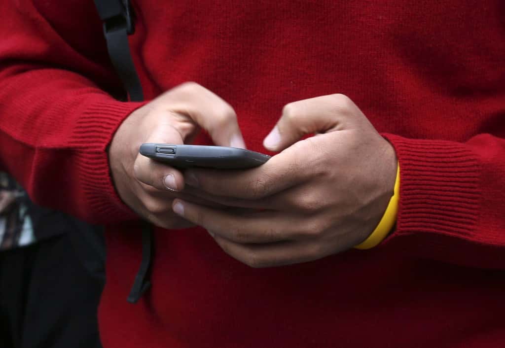 File photo dated 23/10/14 of someone using a mobile phone, as new advice for police suggests that some sexting cases involving children could be handled without launching a full-scale criminal investigation.